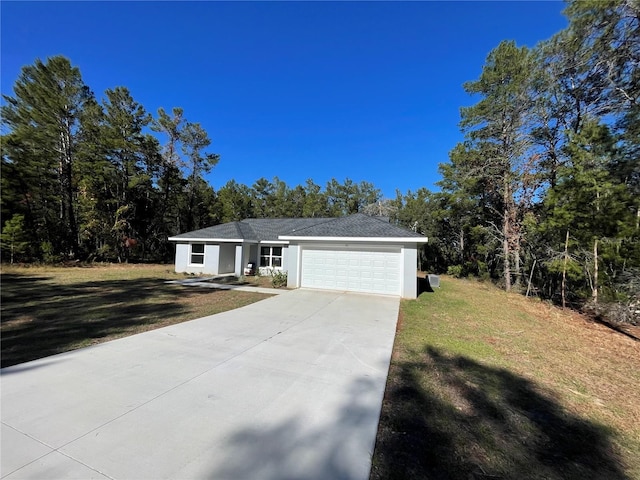 single story home featuring a garage and a front yard