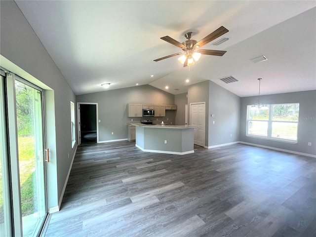 161 Fisher Crse, Ocklawaha, FL 32179 - unfurnished living room featuring vaulted ceiling, dark wood-style flooring, a chandelier, baseboards, and ceiling fan