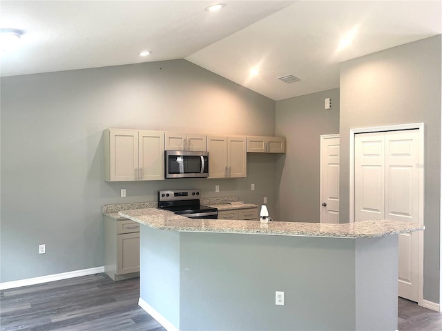 161 Fisher Crse, Ocklawaha, FL 32179 - kitchen with electric range oven, stainless steel microwave, wood finished floors, vaulted ceiling, and baseboards