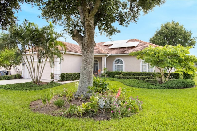 view of front of home featuring a front lawn and solar panels