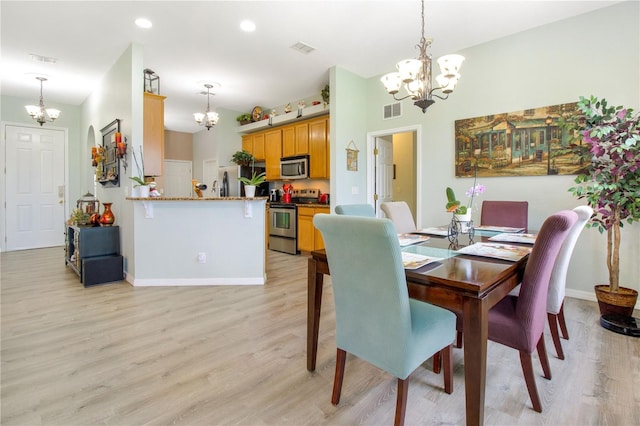 dining area with an inviting chandelier and light wood-type flooring