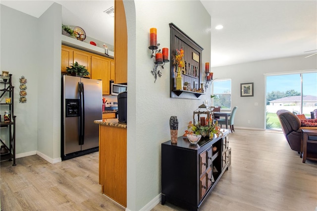 kitchen with light hardwood / wood-style flooring and appliances with stainless steel finishes