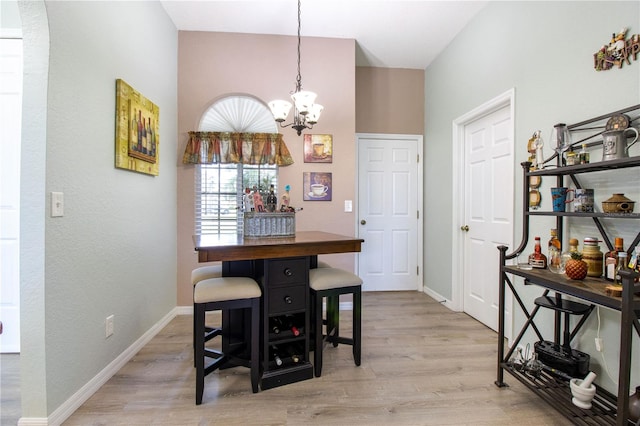 dining area with an inviting chandelier and light wood-type flooring