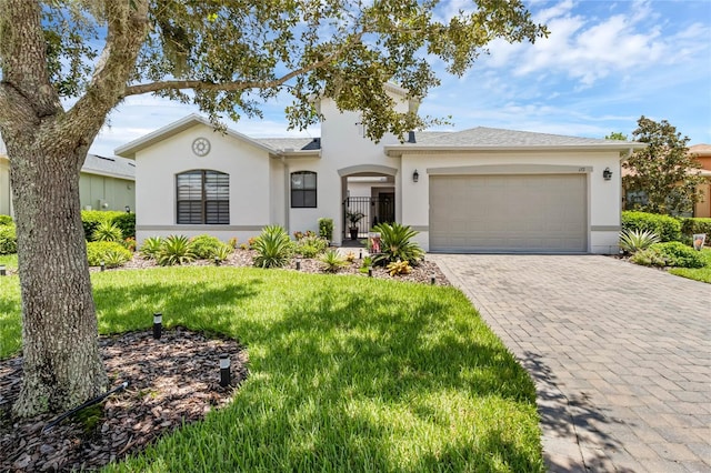 ranch-style home with a garage and a front yard