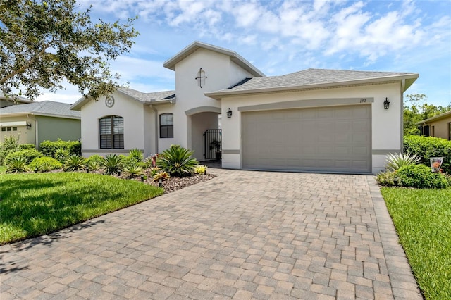 view of front of property with a garage and a front yard