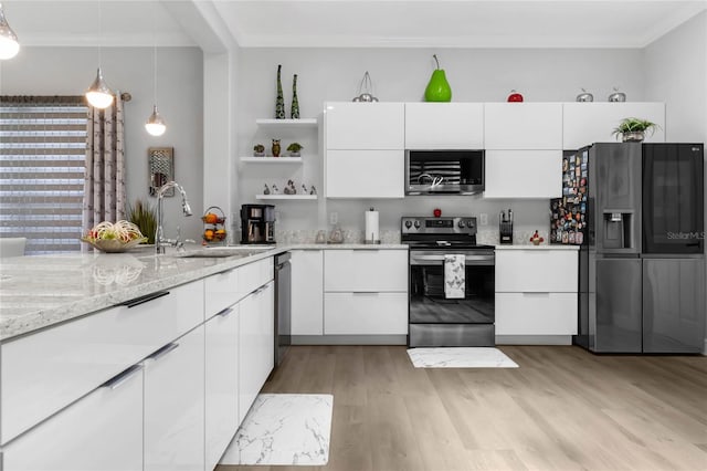 kitchen featuring light hardwood / wood-style flooring, white cabinets, appliances with stainless steel finishes, sink, and ornamental molding