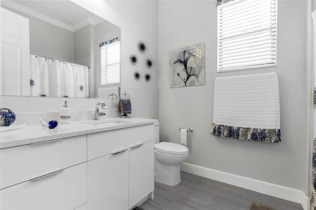 bathroom featuring vanity, crown molding, tile patterned flooring, and toilet