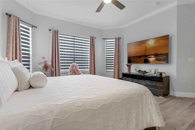 bedroom with crown molding, ceiling fan, and light hardwood / wood-style floors