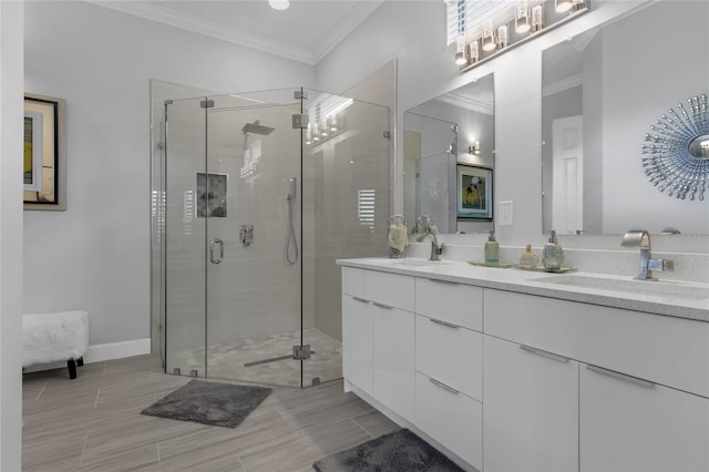 bathroom with tile patterned floors, a shower with door, crown molding, and dual bowl vanity