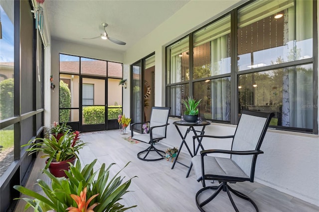 sunroom featuring ceiling fan