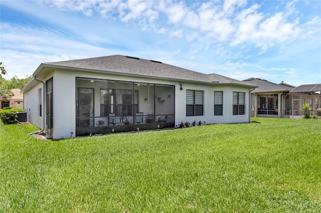 back of property with a sunroom, central AC unit, and a yard