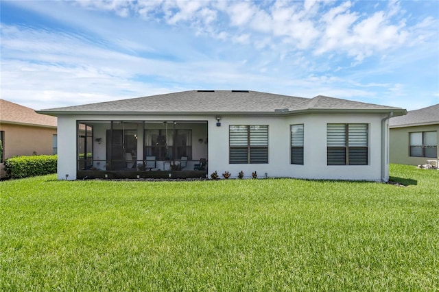 back of house featuring a sunroom and a yard