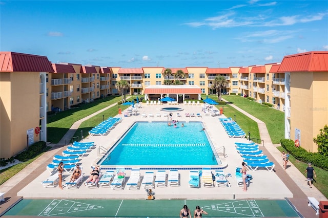 view of swimming pool featuring a patio area and a yard