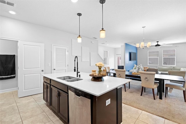 kitchen with a center island with sink, pendant lighting, sink, and stainless steel dishwasher