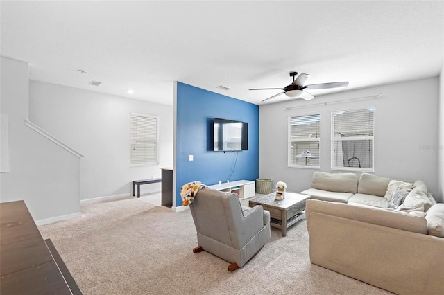 carpeted living room with ceiling fan