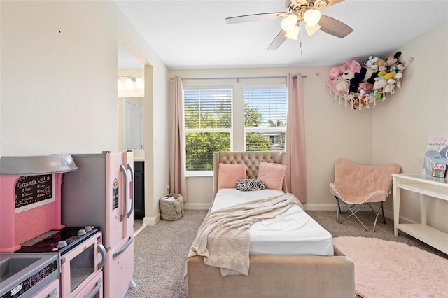 carpeted bedroom with ceiling fan and white refrigerator