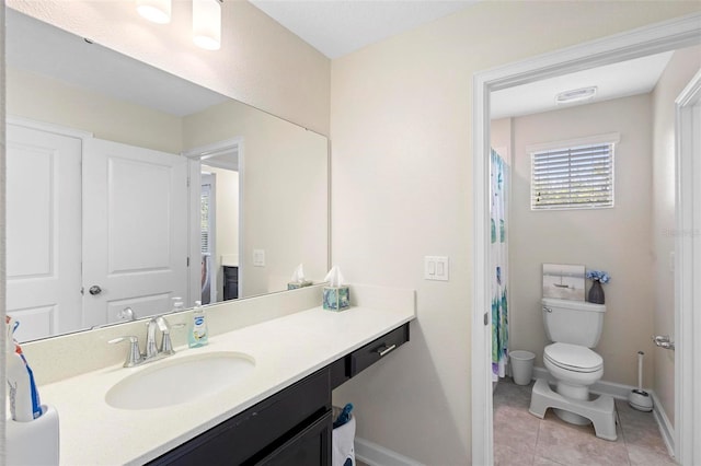 bathroom featuring vanity, toilet, and tile patterned flooring