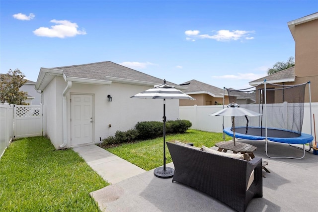 exterior space featuring a trampoline and a patio area