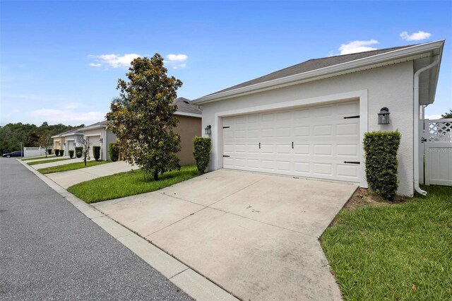 ranch-style home with a garage and a front yard