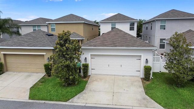 view of front property featuring a garage and a front lawn