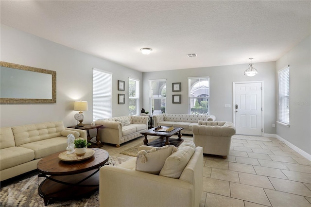 living room featuring light tile patterned floors and a textured ceiling