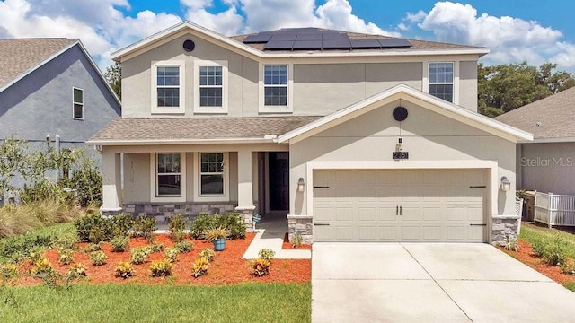 front of property with a garage and solar panels