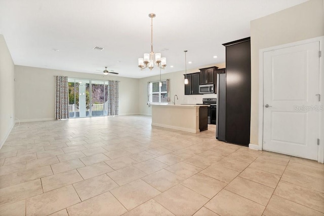 unfurnished living room featuring light tile patterned flooring, ceiling fan with notable chandelier, and sink