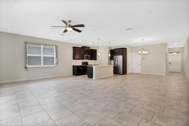 unfurnished living room with ceiling fan with notable chandelier and light tile patterned floors