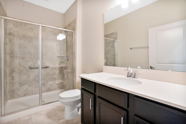 bathroom featuring walk in shower, tile patterned flooring, toilet, and vanity