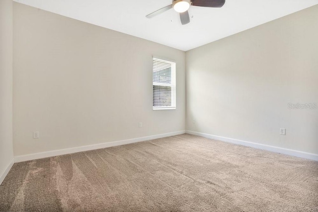 spare room featuring carpet floors and ceiling fan