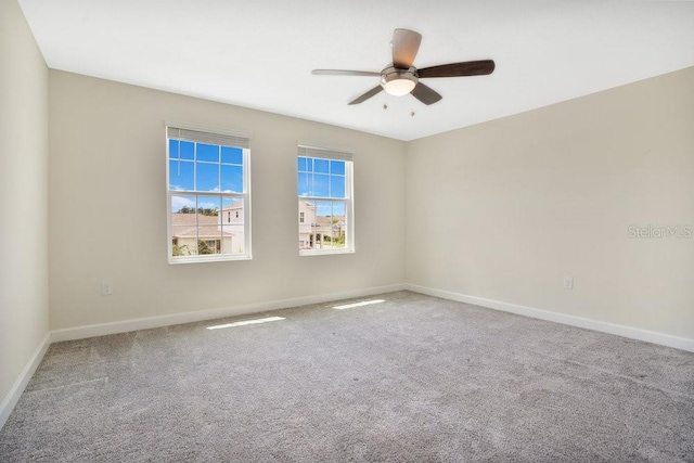 carpeted empty room with ceiling fan