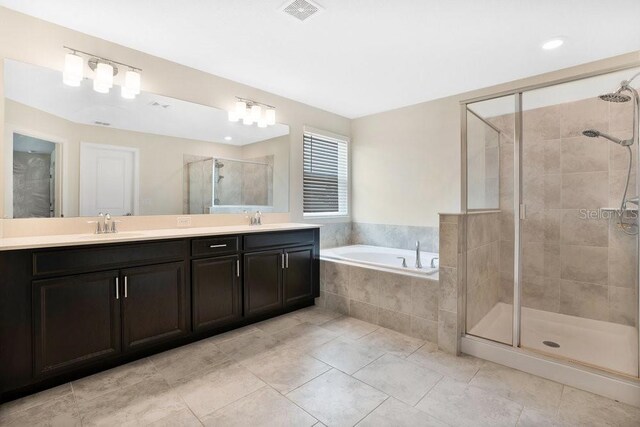 bathroom with double vanity, independent shower and bath, and tile patterned floors