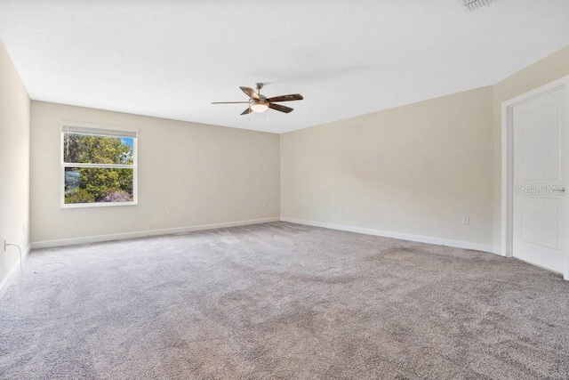 unfurnished room featuring ceiling fan and carpet flooring