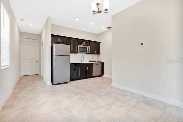 kitchen featuring stainless steel appliances, sink, light tile patterned floors, dark brown cabinetry, and a chandelier