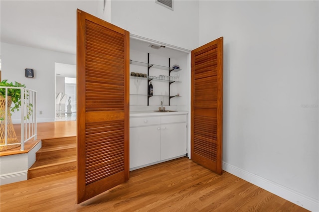 interior space featuring sink and light hardwood / wood-style flooring