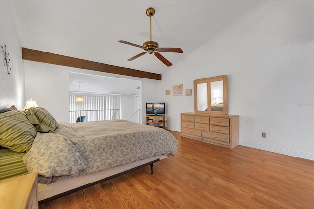 bedroom featuring ceiling fan, wood-type flooring, and vaulted ceiling