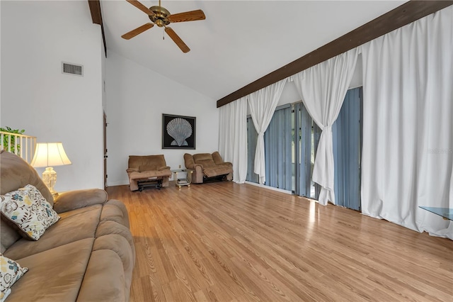 living room with wood-type flooring, high vaulted ceiling, and ceiling fan