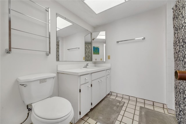 bathroom featuring vanity, tile patterned flooring, and toilet