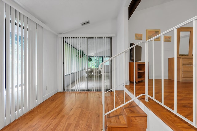 interior space featuring hardwood / wood-style flooring and lofted ceiling