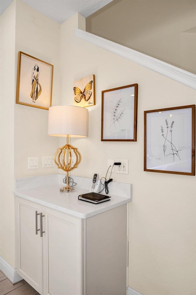 interior space with baseboards and wood finished floors