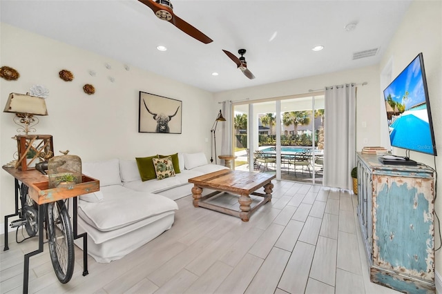 living room featuring a ceiling fan, recessed lighting, wood tiled floor, and visible vents