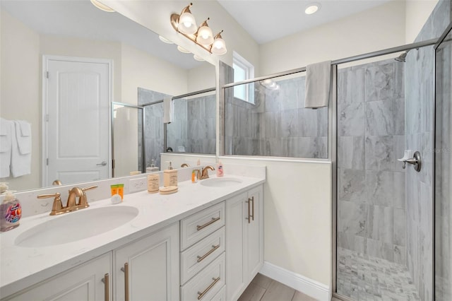 bathroom featuring an enclosed shower and dual bowl vanity