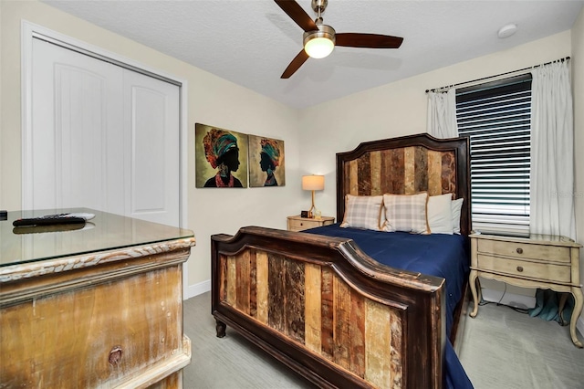 bedroom featuring a ceiling fan and a textured ceiling