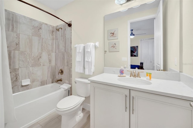 full bathroom with shower / bath combo, tile patterned floors, toilet, vanity, and ceiling fan