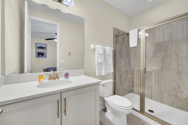 ensuite bathroom with toilet, vanity, a stall shower, and ensuite bath