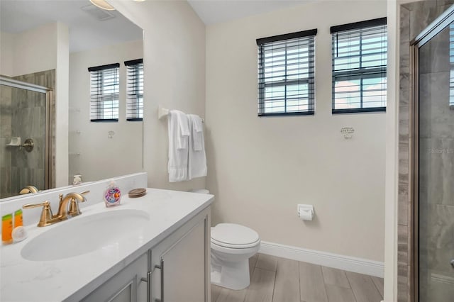 full bath featuring a stall shower, toilet, vanity, baseboards, and visible vents