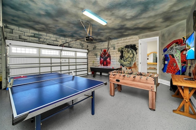 rec room with speckled floor and a garage