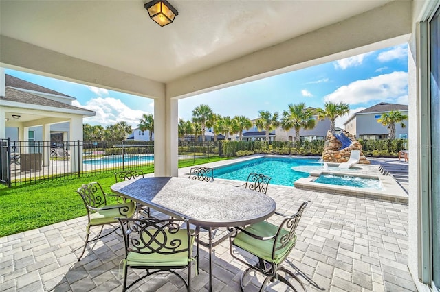 pool featuring fence, outdoor dining area, a patio, and a yard