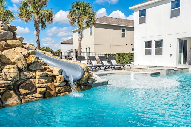 view of swimming pool with fence and a patio