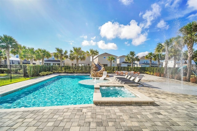 community pool with fence, a residential view, and a patio